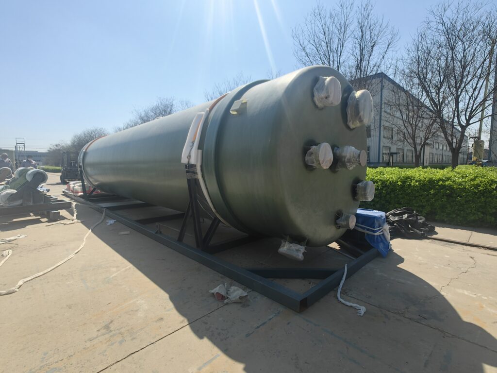 FRP acid wash vessel on its shipping skid, top head with process nozzles