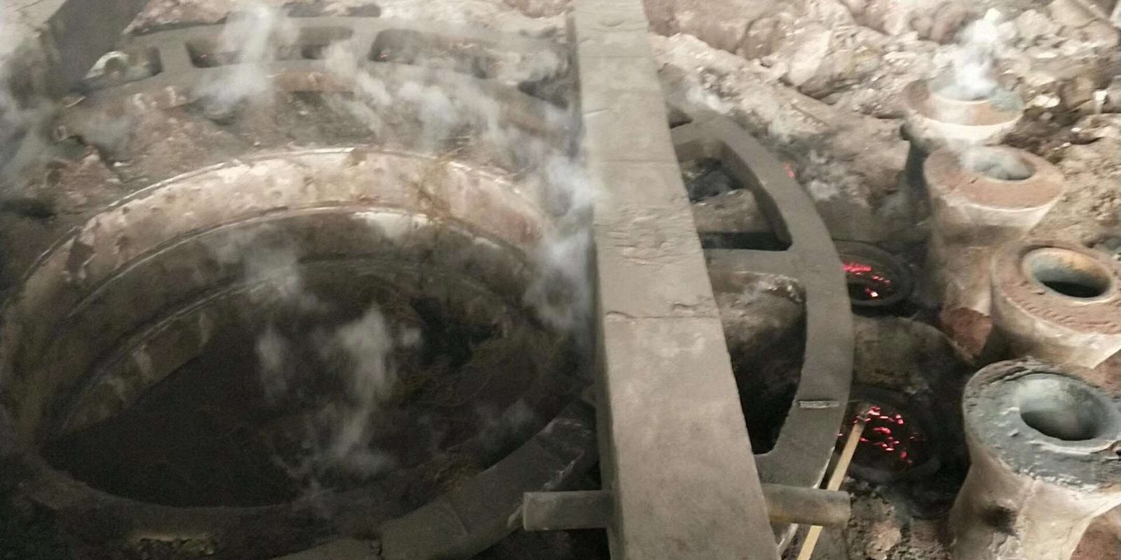 Molten metal being poured in a foundry to cast heavy wear parts and components