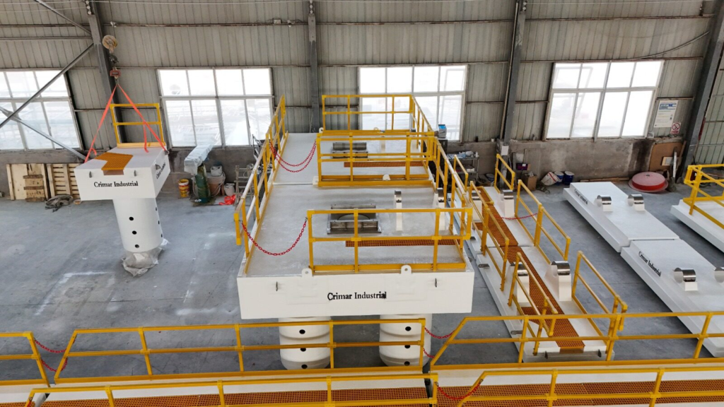 Overhead view of an FRP pump barge deck with yellow handrail, deck openings and the connecting floating walkway