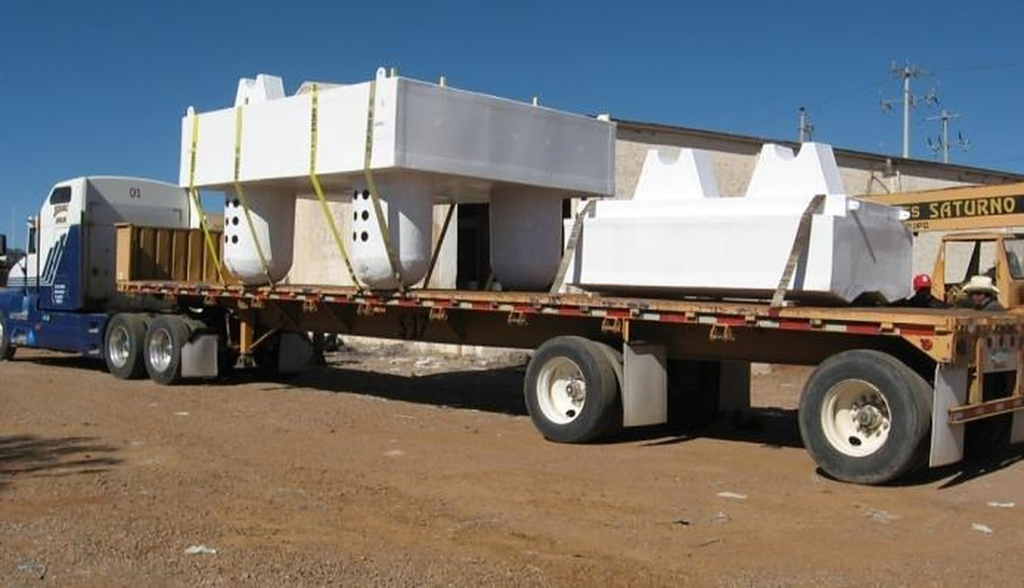 FRP pump barges and pipe floats strapped on a flatbed truck for delivery to a mine